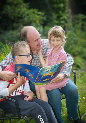 Ed Davey reading to children