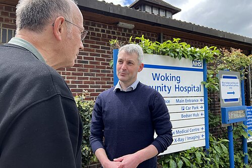 Will Forster outside Woking Community Hospital talking to a resident